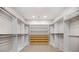 Large, luxurious walk-in closet with custom shelving, drawers, and hanging rods for ample storage at 18 Dorothy Ln, Lawrenceville, GA 30046