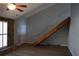 Bright, modern living room features hardwood floors, a unique stone accent wall, and a cozy ceiling fan at 272 Toweridge Dr, Marietta, GA 30064