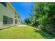 Spacious, well-maintained backyard with a patio, a view of a house, and mature trees at 3283 Sugar Creek Falls Se Ave, Atlanta, GA 30316