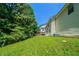 A view of the side of a home from the large grassy backyard at 3283 Sugar Creek Falls Se Ave, Atlanta, GA 30316