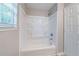 Bright bathroom showcasing a tub/shower combo with white surround, shower head, and window at 3283 Sugar Creek Falls Se Ave, Atlanta, GA 30316