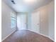 Well-lit bedroom featuring neutral paint, carpet and two doors at 3283 Sugar Creek Falls Se Ave, Atlanta, GA 30316