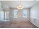Spacious dining area with carpet, neutral paint, wainscoting, and natural light at 3283 Sugar Creek Falls Se Ave, Atlanta, GA 30316