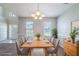 Dining room with table set for eight, decorative chandelier and natural light at 3283 Sugar Creek Falls Se Ave, Atlanta, GA 30316