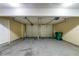 Two-car garage interior, door to the interior and storage containers at 3283 Sugar Creek Falls Se Ave, Atlanta, GA 30316