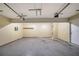 Spacious garage featuring concrete floors, electrical box, and storage shelf at 3283 Sugar Creek Falls Se Ave, Atlanta, GA 30316