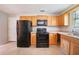 Cozy kitchen with classic wood cabinets, black appliances, and plenty of counter space at 3283 Sugar Creek Falls Se Ave, Atlanta, GA 30316