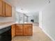 Open kitchen with wooden cabinets, offering a view into the living room with a fireplace at 3283 Sugar Creek Falls Se Ave, Atlanta, GA 30316
