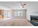 The unfurnished living room features a fireplace, large windows, and access to kitchen at 3283 Sugar Creek Falls Se Ave, Atlanta, GA 30316