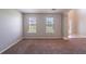 Open living room space with two large windows and neutral color palette at 3283 Sugar Creek Falls Se Ave, Atlanta, GA 30316
