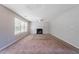 The unfurnished living room features a fireplace, large windows, and neutral carpeting at 3283 Sugar Creek Falls Se Ave, Atlanta, GA 30316