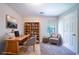 Home office features a work desk, shelves, chair and window at 3283 Sugar Creek Falls Se Ave, Atlanta, GA 30316
