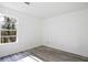 Bright bedroom with wood-look flooring and a large window with outdoor views at 3845 Springleaf Ct, Stone Mountain, GA 30083