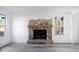 Cozy living room showcasing a stone fireplace, ample natural light, and new flooring at 3845 Springleaf Ct, Stone Mountain, GA 30083