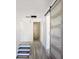 Hallway view showing bathroom with marble wall and modern sliding door at 3845 Springleaf Ct, Stone Mountain, GA 30083