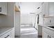 Bright open floorplan showcases modern kitchen with white cabinets and adjoining airy living space at 3845 Springleaf Ct, Stone Mountain, GA 30083