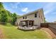 Backyard view of home and outdoor covered seating area. The yard is surrounded by mature trees at 4371 Wigley Preserve Dr, Marietta, GA 30066