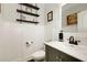 Stylish powder room with custom wall trim, floating shelves, and a modern vanity at 4371 Wigley Preserve Dr, Marietta, GA 30066