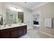 Bathroom with warm tones, white countertops, dark cabinets, and tile flooring at 4371 Wigley Preserve Dr, Marietta, GA 30066