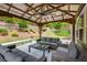 Relax in a large covered patio with comfortable seating, perfect for outdoor gatherings and enjoyment of the surrounding landscape at 4371 Wigley Preserve Dr, Marietta, GA 30066