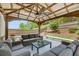 Covered outdoor seating area equipped with fans and patio furniture, ideal for enjoying the beautifully landscaped backyard at 4371 Wigley Preserve Dr, Marietta, GA 30066