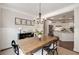 Elegant dining room with hardwood floors, chandelier, and access to a modern kitchen at 4371 Wigley Preserve Dr, Marietta, GA 30066