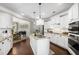 Modern kitchen with a center island, granite countertops, stainless appliances, and an open dining area at 4371 Wigley Preserve Dr, Marietta, GA 30066