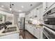 Bright kitchen featuring stainless steel appliances, granite countertops, and white cabinets at 4371 Wigley Preserve Dr, Marietta, GA 30066