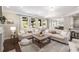 Comfortable living room with large sofa, ample windows, neutral tones, and seamless flow into the kitchen at 4371 Wigley Preserve Dr, Marietta, GA 30066