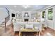Open-concept living room featuring a fireplace, built-in shelves, large windows, and hardwood floors at 4371 Wigley Preserve Dr, Marietta, GA 30066