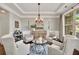 Elegant living room featuring tray ceilings, large window and comfortable seating arrangement at 4371 Wigley Preserve Dr, Marietta, GA 30066