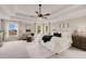 Sun-filled main bedroom featuring tray ceiling, fan, and multiple windows for natural light at 4371 Wigley Preserve Dr, Marietta, GA 30066