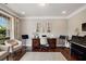 Bright, sunlit sitting room with musical instruments and hardwood floors at 4371 Wigley Preserve Dr, Marietta, GA 30066
