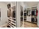 Bright walk-in closet with custom shelving, a mirror and hardwood floors provides maximum storage at 4371 Wigley Preserve Dr, Marietta, GA 30066