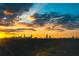 Dramatic cityscape featuring a stunning sunset over a tree line highlighting the Atlanta skyline at 936 Ormewood Se Ter, Atlanta, GA 30316
