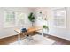 Bright home office featuring hardwood floors, a standing desk, and large windows at 936 Ormewood Se Ter, Atlanta, GA 30316