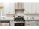 Well-equipped kitchen features stainless steel appliances, subway tile backsplash, and granite countertops at 936 Ormewood Se Ter, Atlanta, GA 30316