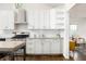 Modern kitchen featuring white cabinets, subway tile backsplash, and stainless steel appliances at 936 Ormewood Se Ter, Atlanta, GA 30316