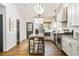 Modern kitchen with white cabinets, a center island, and stainless steel appliances under a skylight at 936 Ormewood Se Ter, Atlanta, GA 30316