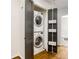 Efficient laundry area with stacked washer and dryer and folding doors at 936 Ormewood Se Ter, Atlanta, GA 30316