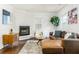 Cozy living room featuring a leather sectional, fireplace, hardwood floors, and natural light at 936 Ormewood Se Ter, Atlanta, GA 30316