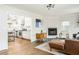 Bright open living room features a fireplace and an open view to the kitchen and stainless steel appliances at 936 Ormewood Se Ter, Atlanta, GA 30316