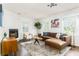 Cozy living room with a leather sectional sofa, fireplace, natural light, and stylish decor at 936 Ormewood Se Ter, Atlanta, GA 30316