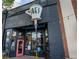 Unique restaurant exterior with a giant coffee cup, black brick, and charming bistro seating at 936 Ormewood Se Ter, Atlanta, GA 30316