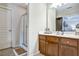 Bathroom featuring a stand-up shower and wood vanity at 1233 Miss Irene Ln, Lawrenceville, GA 30044