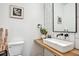 Elegant half-bathroom featuring a modern vessel sink, sleek faucet, and stylish decor at 1233 Miss Irene Ln, Lawrenceville, GA 30044