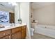 Bathroom boasts wooden cabinets, white countertops, and a soaking tub, exuding comfort at 1233 Miss Irene Ln, Lawrenceville, GA 30044