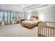 Spacious bedroom features a tray ceiling, neutral walls, and large windows at 1233 Miss Irene Ln, Lawrenceville, GA 30044