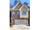 Charming two-story townhouse with brick and siding exterior and attached two-car garage at 1233 Miss Irene Ln, Lawrenceville, GA 30044