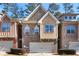 Inviting two-story townhouse with a brick facade, siding accents, and an attached garage at 1233 Miss Irene Ln, Lawrenceville, GA 30044